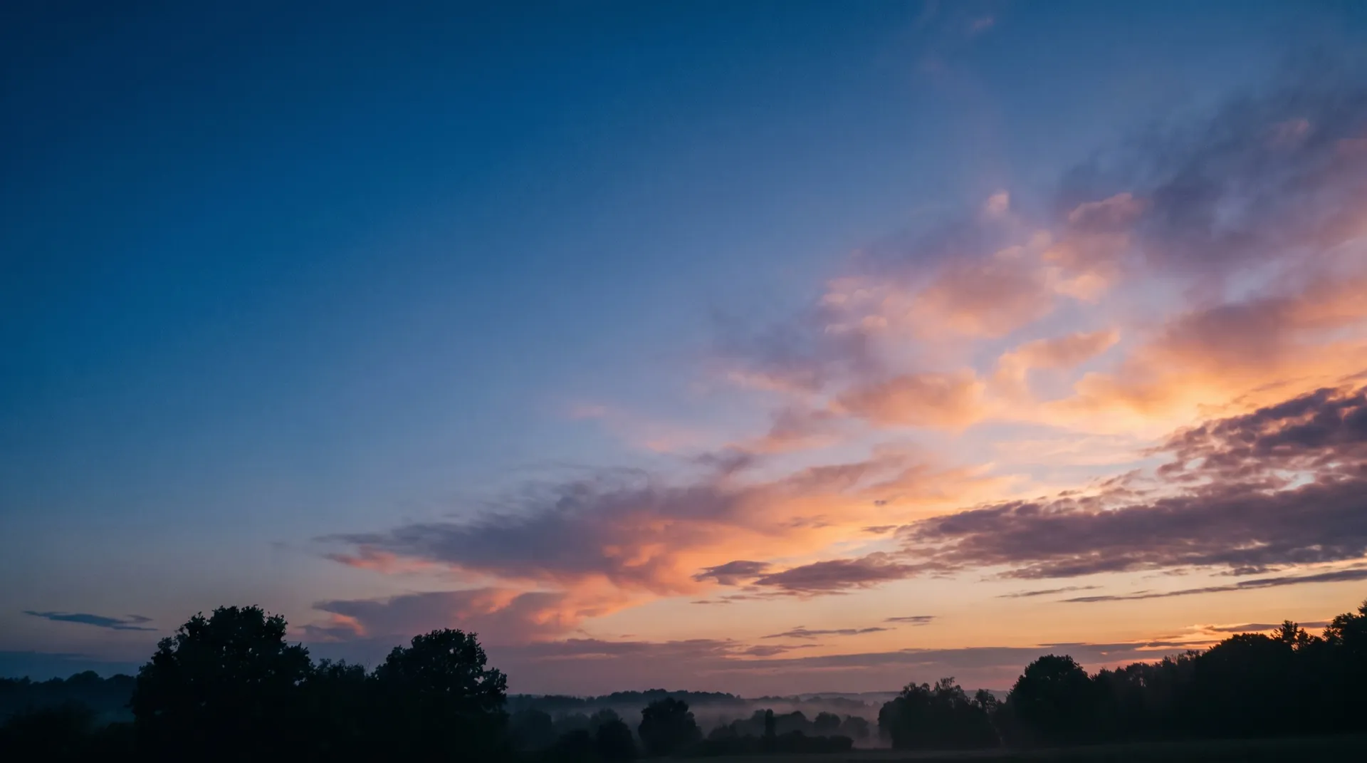Warm sunrise sky over an open horizon